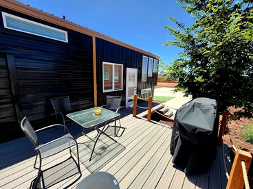 Modern Comforts, Rustic Charm: Tiny House Hideaway with Deck in Apple Valley - Apple Valley, Utah - glamping.directory
