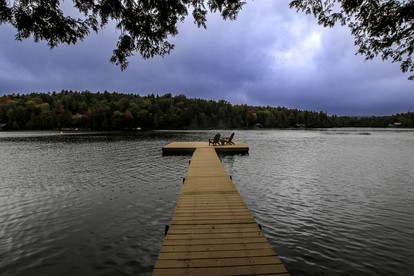 Cozy Cottage Surrounded by Trees with Private Dock for a Peaceful Escape by Big Moose Lake in New York - Webb, New York - glamping.directory