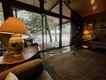 Cozy Cottage Surrounded by Trees with Private Dock for a Peaceful Escape by Big Moose Lake in New York - Webb, New York - glamping.directory