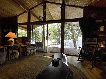 Cozy Cottage Surrounded by Trees with Private Dock for a Peaceful Escape by Big Moose Lake in New York - Webb, New York - glamping.directory