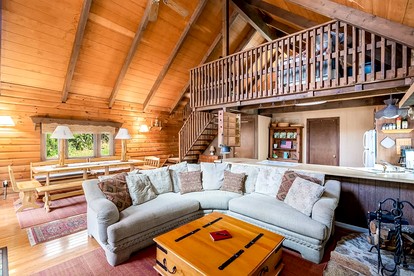 Log Cabin with Hot Tub, Fire Pit and Spacious Deck Nestled in the Woods of Great Cacapon, WV - Great Cacapon, West Virginia - glamping.directory
