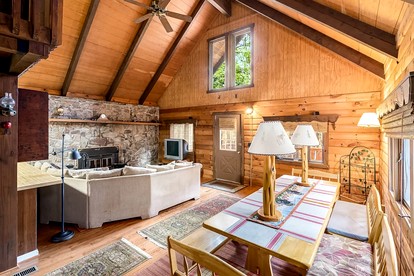 Log Cabin with Hot Tub, Fire Pit and Spacious Deck Nestled in the Woods of Great Cacapon, WV - Great Cacapon, West Virginia - glamping.directory
