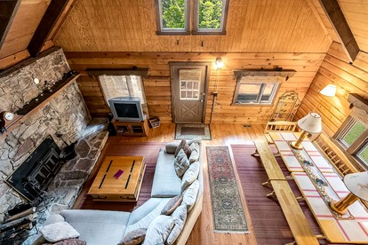 Log Cabin with Hot Tub, Fire Pit and Spacious Deck Nestled in the Woods of Great Cacapon, WV - Great Cacapon, West Virginia - glamping.directory