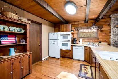 Log Cabin with Hot Tub, Fire Pit and Spacious Deck Nestled in the Woods of Great Cacapon, WV - Great Cacapon, West Virginia - glamping.directory