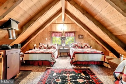 Log Cabin with Hot Tub, Fire Pit and Spacious Deck Nestled in the Woods of Great Cacapon, WV - Great Cacapon, West Virginia - glamping.directory