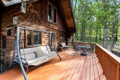 Log Cabin with Hot Tub, Fire Pit and Spacious Deck Nestled in the Woods of Great Cacapon, WV - Great Cacapon, West Virginia - glamping.directory