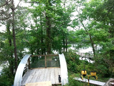 Eclectic Riverfront Log Cabin and Artist Retreat for Groups in Castle Hayne, North Carolina - Castle Hayne, North Carolina - glamping.directory