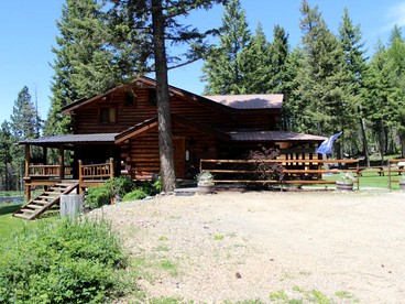 Authentic Cabin Rental with Hot Tub and Mountain Views in Columbia Falls, Montana - glamping.directory