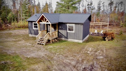 Secluded Rustic Cabin with Hot Tub Near Pere Marquette River in Big Rapids, Michigan - glamping.directory