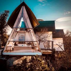 Luxury Glass A-Frame Escape with Cliffside Balcony & Spa Features in Cottonwood Shores, Texas - Cottonwood Shores, Texas - glamping.directory