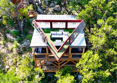 Epic Treehouse Escape with Multi-Level Deck & Hanging Bed in Cottonwood, Texas - glamping.directory