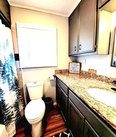 Lakefront Family Cabin with Jacuzzi, Fire Pit and Yard in Texas - Karnack, Texas - glamping.directory