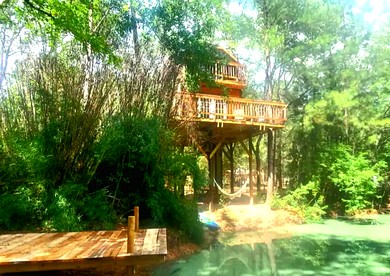 Fun for All Ages: Treehouse with Waterfront Deck for Families in Grimes County, TX - glamping.directory