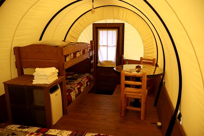Rustic Conestoga Wagon Stay with Lodge Amenities near Boulder Creek, Montana - Hall, Montana - glamping.directory
