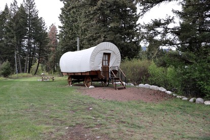 Rustic Conestoga Wagon Stay with Lodge Amenities near Boulder Creek, Montana - Hall, Montana - glamping.directory