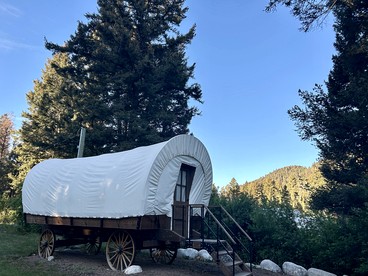 Rustic Conestoga Wagon Stay with Lodge Amenities near Boulder Creek, Montana - glamping.directory