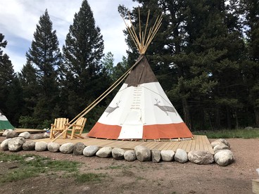 Rustic Conestoga Wagon Stay with Lodge Amenities near Boulder Creek, Montana - Hall, Montana - glamping.directory