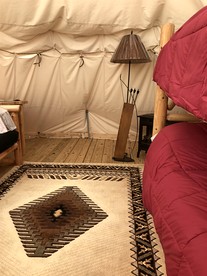 Rustic Conestoga Wagon Stay with Lodge Amenities near Boulder Creek, Montana - Hall, Montana - glamping.directory