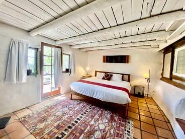 Log Casita Overlooking Pond and Waterfall near Taos, New Mexico - Taos Ski Valley, New Mexico - glamping.directory