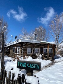 Log Casita Overlooking Pond and Waterfall near Taos, New Mexico - Taos Ski Valley, New Mexico - glamping.directory