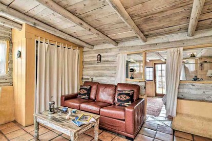 Log Casita Overlooking Pond and Waterfall near Taos, New Mexico - Taos Ski Valley, New Mexico - glamping.directory