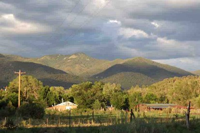 Log Casita Overlooking Pond and Waterfall near Taos, New Mexico - Taos Ski Valley, New Mexico - glamping.directory