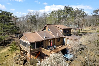 Extraordinary Group Retreat with Hot Tub, Fire Pit, Wraparound Deck in Great Cacapon, WV - Great Cacapon, West Virginia - glamping.directory