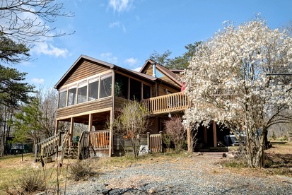 Extraordinary Group Retreat with Hot Tub, Fire Pit, Wraparound Deck in Great Cacapon, WV - glamping.directory