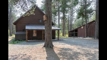 Rustic Cabin Retreat with Private Pond & Hot Tub near Island Park, Idaho - glamping.directory