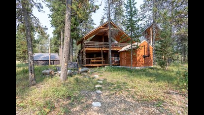 Rustic Cabin Retreat with Private Pond & Hot Tub near Island Park, Idaho - Island Park, Idaho - glamping.directory