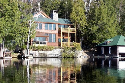 Stunning Waterfront Cabin with a Boathouse on Tupper Lake in New York - glamping.directory