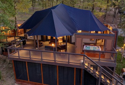 Hot Springs Retreat: Luxe Tented Cabin with Waterfront Views and Hot Tub - glamping.directory