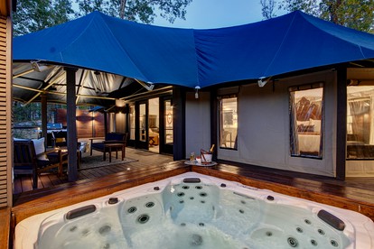 Hot Springs Retreat: Luxe Tented Cabin with Waterfront Views and Hot Tub - Hot Springs, Arkansas - glamping.directory