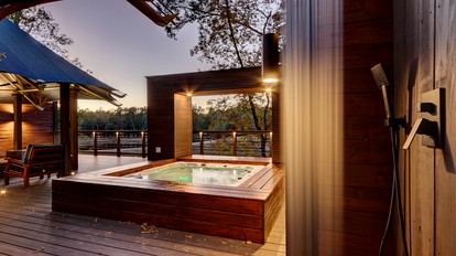 Hot Springs Retreat: Luxe Tented Cabin with Waterfront Views and Hot Tub - Hot Springs, Arkansas - glamping.directory