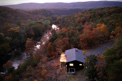 Secluded, Solar Powered Log Cabin on the Great Cacapon River, Perfect for Large Group Getaways to the West Virginia Wilderness - Great Cacapon, West Virginia - glamping.directory