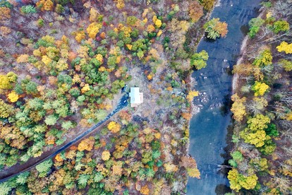 Secluded, Solar Powered Log Cabin on the Great Cacapon River, Perfect for Large Group Getaways to the West Virginia Wilderness - Great Cacapon, West Virginia - glamping.directory