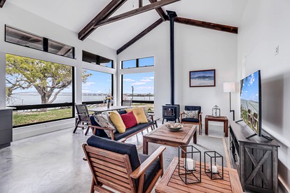 Stylish Waterfront Vacation Rental with Boat Dock and Golf Course in Rockport, Texas - Rockport, Texas - glamping.directory