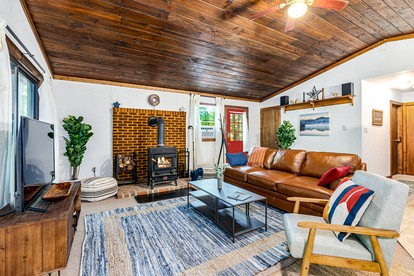 River Cabin with Hot Tub, Fire Pit, Screened Porch and Plenty of Outdoor Activities to Keep Your Group Busy in Great Cacapon, WV - Great Cacapon, West Virginia - glamping.directory