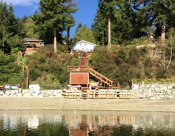 Amazing Sunrise at Coastal Luxury Cabin Rental on Herron Island with Fire Pit and Paddle Boarding near Olympia, Washington - glamping.directory