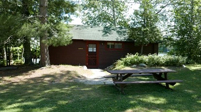 Serene Lakefront Cabin with Picture-Window Fishing Beside Covered Boathouse in Orr, Minnesota - glamping.directory
