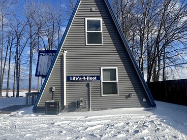 Lakefront A-Frame with Lofted Interior Ideal for Outdoor Activities in Michigan - Au Gres, Michigan - glamping.directory