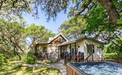 Romantic Log Cabin Retreat with Private Hot Tub Located in Fredericksburg, Texas - glamping.directory
