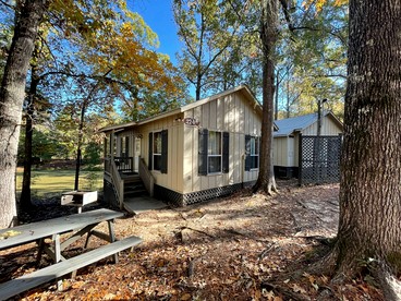 Scenic Waterfront Cabin with Covered Porch Overlooking Private Pond near Zwolle, Louisiana - glamping.directory
