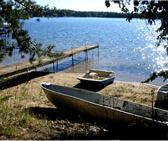 Rustic Lakeside Cabin Rental with a Paddleboat and Canoe in Rhinelander, Wisconsin - Rhinelander, Wisconsin - glamping.directory