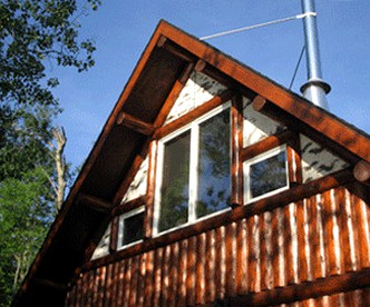 Rustic Lakeside Cabin Rental with a Paddleboat and Canoe in Rhinelander, Wisconsin - Rhinelander, Wisconsin - glamping.directory