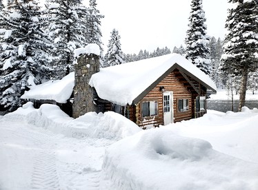 Charming Riverfront Cabin with Hot Tub and Dock Access Near Scenic Trails in Island Park, Idaho - glamping.directory