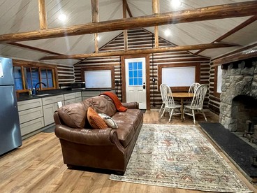 Charming Riverfront Cabin with Hot Tub and Dock Access Near Scenic Trails in Island Park, Idaho - Island Park, Idaho - glamping.directory