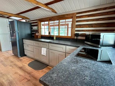 Charming Riverfront Cabin with Hot Tub and Dock Access Near Scenic Trails in Island Park, Idaho - Island Park, Idaho - glamping.directory