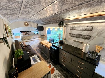 Rustic Converted School Bus with Outdoor Shower Near ORV Trails in Manistee National Forest, Michigan - Bitely, Michigan - glamping.directory