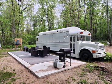 Rustic Converted School Bus with Outdoor Shower Near ORV Trails in Manistee National Forest, Michigan - Bitely, Michigan - glamping.directory